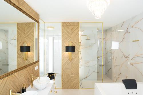 a bathroom with a shower and a white sink at Penthouse apartments MINI s privátnou vírivou vaňou in Trstená