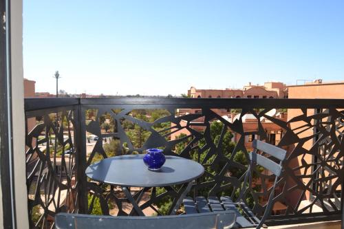 a blue vase sitting on a table on a balcony at AiM HOUSE in Marrakech