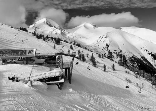 a ski lodge on a snowy mountain with a ski lift at Ground floor 2-bedrooms, 2-bathrooms apartment near Bansko in a complex with pools and SPA included in Razlog