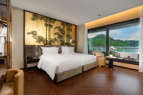 a bedroom with a white bed and a large window at Sea Stars Cruise Ha Long Bay in Ha Long