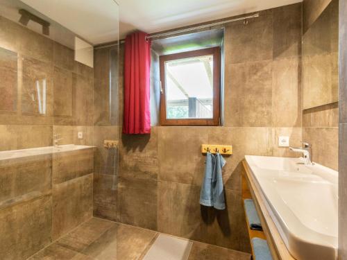 a bathroom with a sink and a tub and a shower at beautifully renovated farmhouse Stoanerbauer with a wonderful view in Dorf