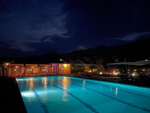 a swimming pool at night with the lights on at Sea View apartment in Dahab