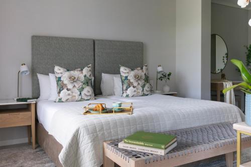 a bedroom with a bed with a tray of books at De Zalze Lodge in Stellenbosch