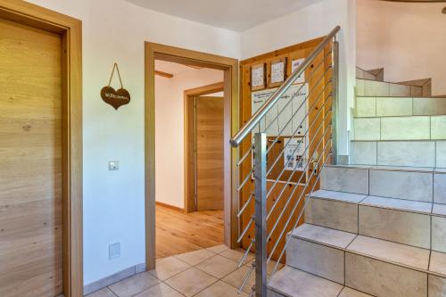 a staircase in a home with wooden floors at Mongaduierhof Apt Latemar in Umes