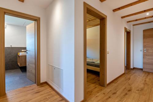 a bedroom with a door leading to a bed at Mongaduierhof Apt Latemar in Umes
