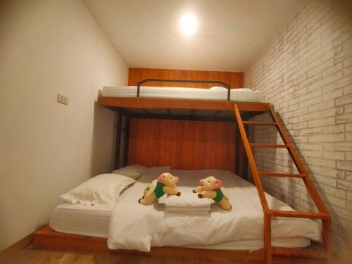 a bunk bed with two teddy bears sitting on it at innbox Chiangmai Hotel in Ban Si Ngam