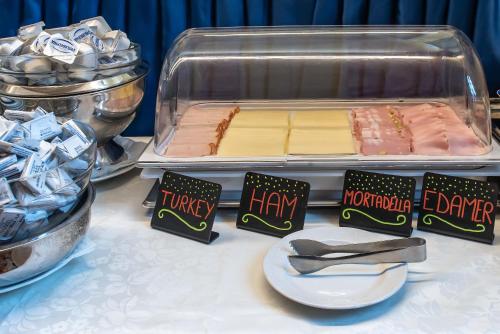 a table with a tray signs and food at Hotel La Fenice et Des Artistes in Venice