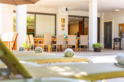 a dining room with a table and chairs at Villa Diagonal in Can Picafort