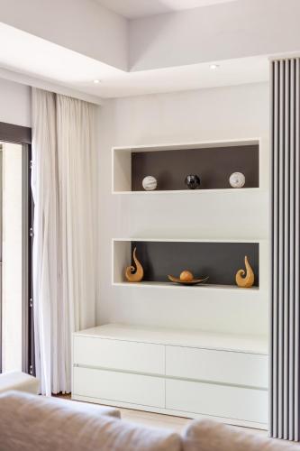 a bedroom with white shelves and a bed at Villa Diagonal in Can Picafort