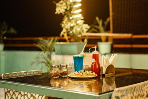 a table with a plate of food and drinks on it at Hotel Naman in Udaipur