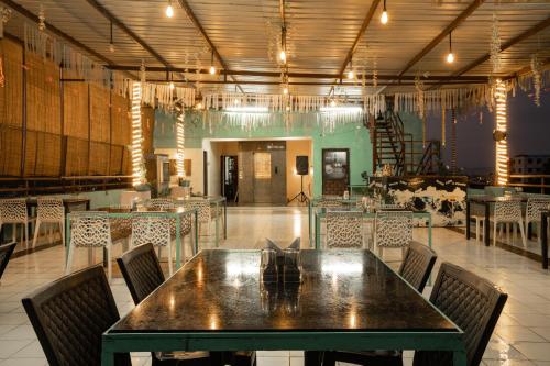 a dining room with a table and chairs at Hotel Naman in Udaipur
