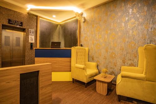 a waiting room with two chairs and a table at Hotel Naman in Udaipur