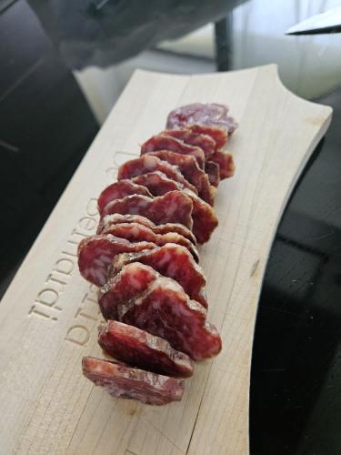 a group of bacon on a wooden cutting board at Cà Marinet 1931 - Tresivio - Sondrio in Tresivio