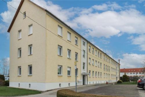 a large yellow building on the side of a street at Ferienwohnung mit Tageslichtbad in ländlicher Lage nahe Halle (Saale) in Landsberg