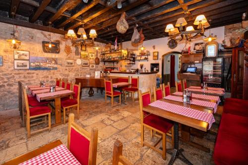 a restaurant with tables and chairs in a room at Heritage Hotel Tragos in Trogir