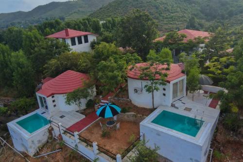 an aerial view of a house with a swimming pool at The HighGarden Resort in Udaipur