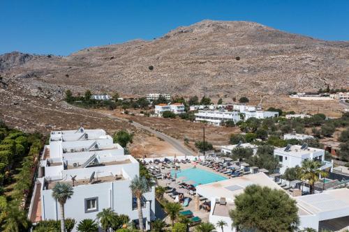 an aerial view of a resort with a mountain in the background at Lambis Studios & Apartments in Líndos