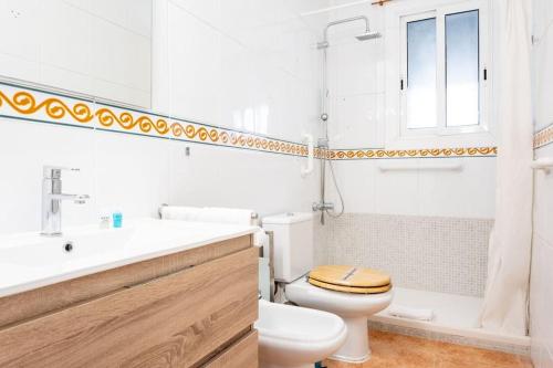 a white bathroom with a toilet and a sink at GuestReady - Vintage Elegance in Catalonia in Cornellà de Llobregat