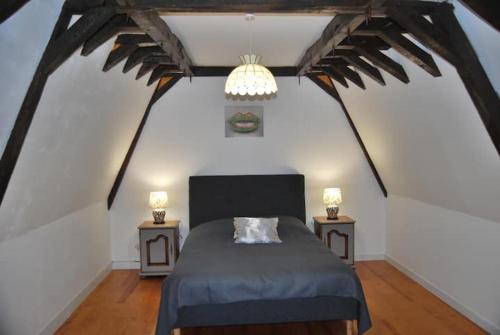 a bedroom with a bed and two night stands at Château des Princes " Fleur de Lys " in Sedan