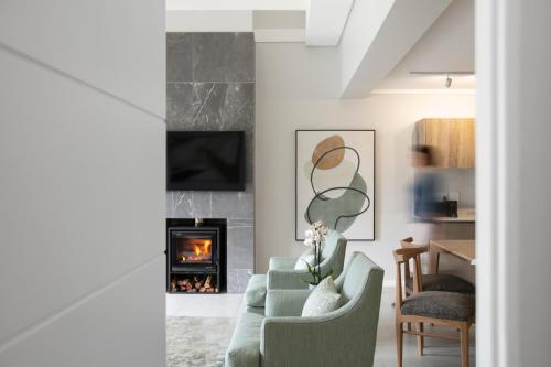 a living room with a green couch and a fireplace at De Zalze Lodge in Stellenbosch