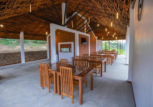 a dining room with wooden tables and chairs at Dowa Elegance Resort in Ella
