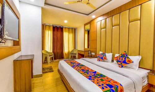 a bedroom with a large bed in a room at FabExpress Clock View in Mussoorie