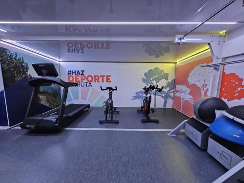 a gym with two exercise bikes in a room at Andamur San Román in San Román