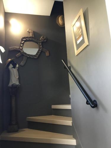 a room with a staircase with a snake on the wall at BnB Montacutain in Montaigu-Vendée