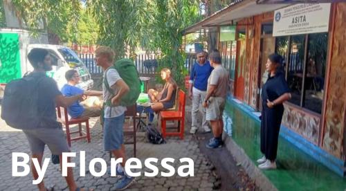 a group of people standing outside of a store at Guest House Dorm Floressa in Maumere