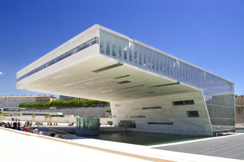 a large white building with people walking around it at ibis Marseille Centre Euromed in Marseille