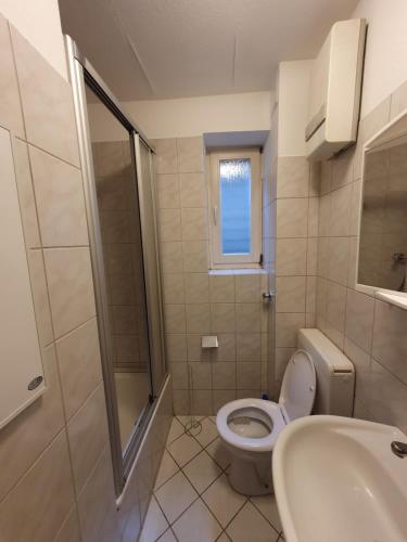 a bathroom with a toilet and a sink at Appartement im Herzen von Langenberg in Velbert