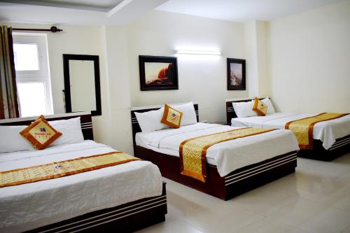 Ліжко або ліжка в номері Thanh An Hotel