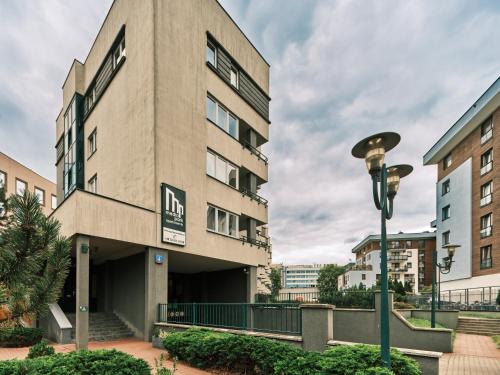 a building with a street light in front of it at Apartamenty Media Park in Warsaw