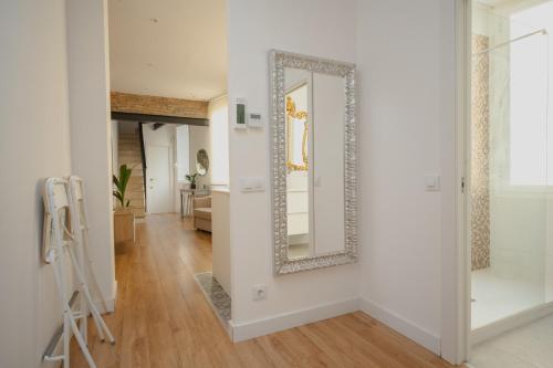 a hallway with a mirror on a wall at Villa Conde in Hospitalet de Llobregat