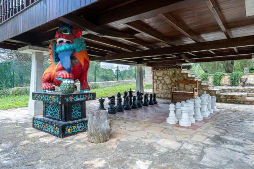 a statue of a lion with a giant chess set at Horrio in Querol