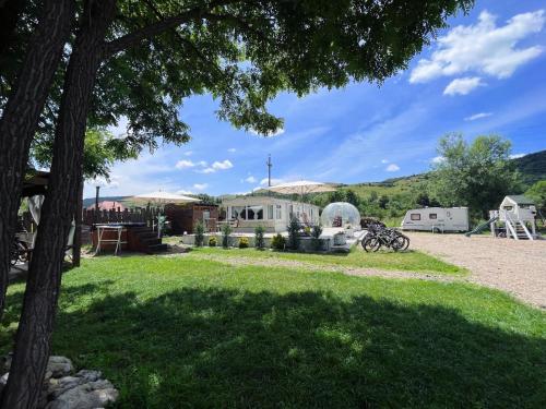 a view of a yard with a house at Kinder Valley Morlaca Cluj in Cluj-Napoca