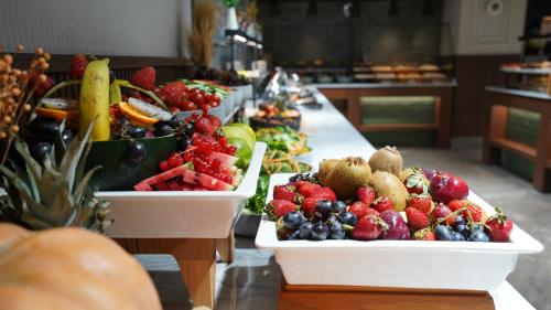 two white trays of fruits and vegetables on a table at Grand Sirkeci Hotel in Istanbul