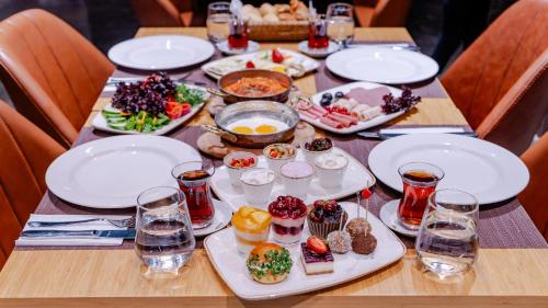 a wooden table with plates of food on it at Grand Sirkeci Hotel in Istanbul