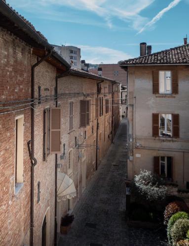 an alley in an old town with brick buildings at Hotel Residenza la Ceramica in Fabriano