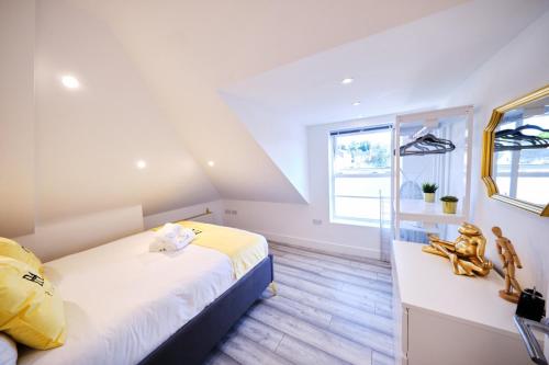 a bedroom with two beds and a window at Pluxa Lemon Quartz - Wi-Fi, Workspace, Parking, in Sutton in Sutton