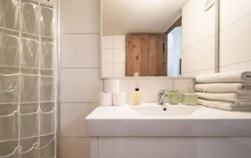 y baño con lavabo, espejo y toallas. en Studio Trendy Kerem center tel aviv, en Tel Aviv