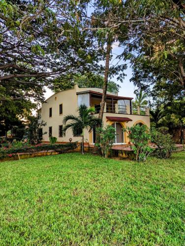 a house with a lawn in front of it at Le Pleiadi in Malindi