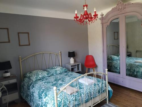 a bedroom with a bed and a mirror at gîte St Pierre in Melle