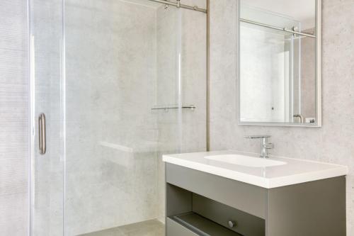 a white bathroom with a sink and a shower at Downtown 1BR w Pool Gym WD nr Staples Center LAX-545 in Los Angeles