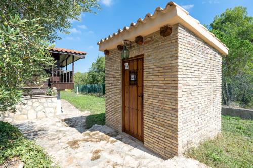 a small brick building with a wooden door at Horrio in Querol