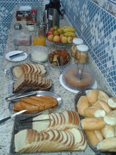 a table topped with lots of different types of bread at Hotel Porto Real in Pôrto Real