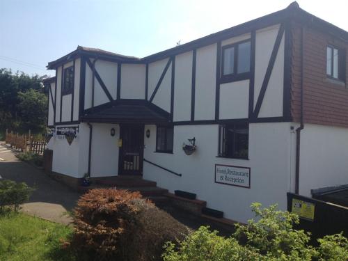 a white house with a black and white facade at The Heath Inn in Leighton Buzzard