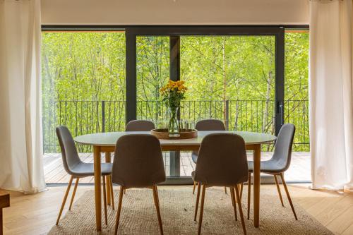 a dining room with a table and chairs and a window at Teatralna1 in Piechowice