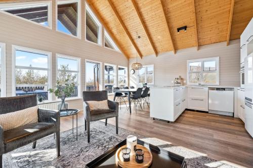 a kitchen and living room with a table and chairs at Cosy Cabin on the Golden Circle in Selfoss