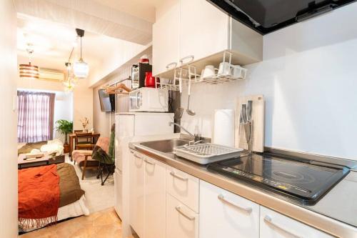 cocina con fregadero y nevera en #803 Opening sale! Private rental Osaka city central Has the longest shopping street and you can enjoy the real Osaka, which has not yet become a tourist destination, en Osaka